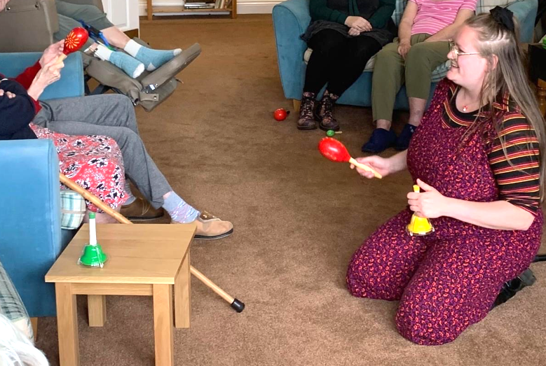 A music therapy session — participants playing instruments together
